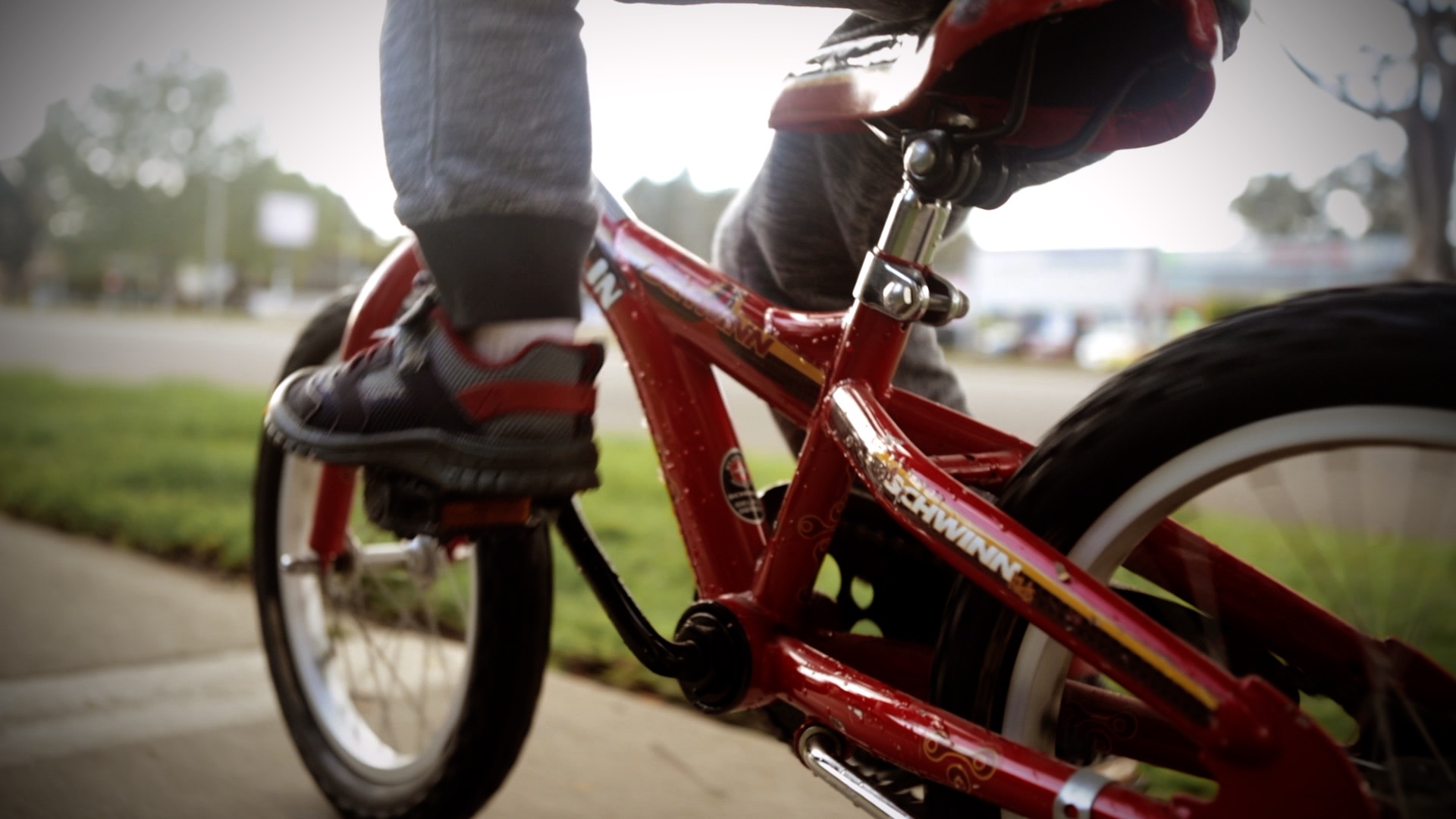 close-up of a boys feet on the pedals of his bike