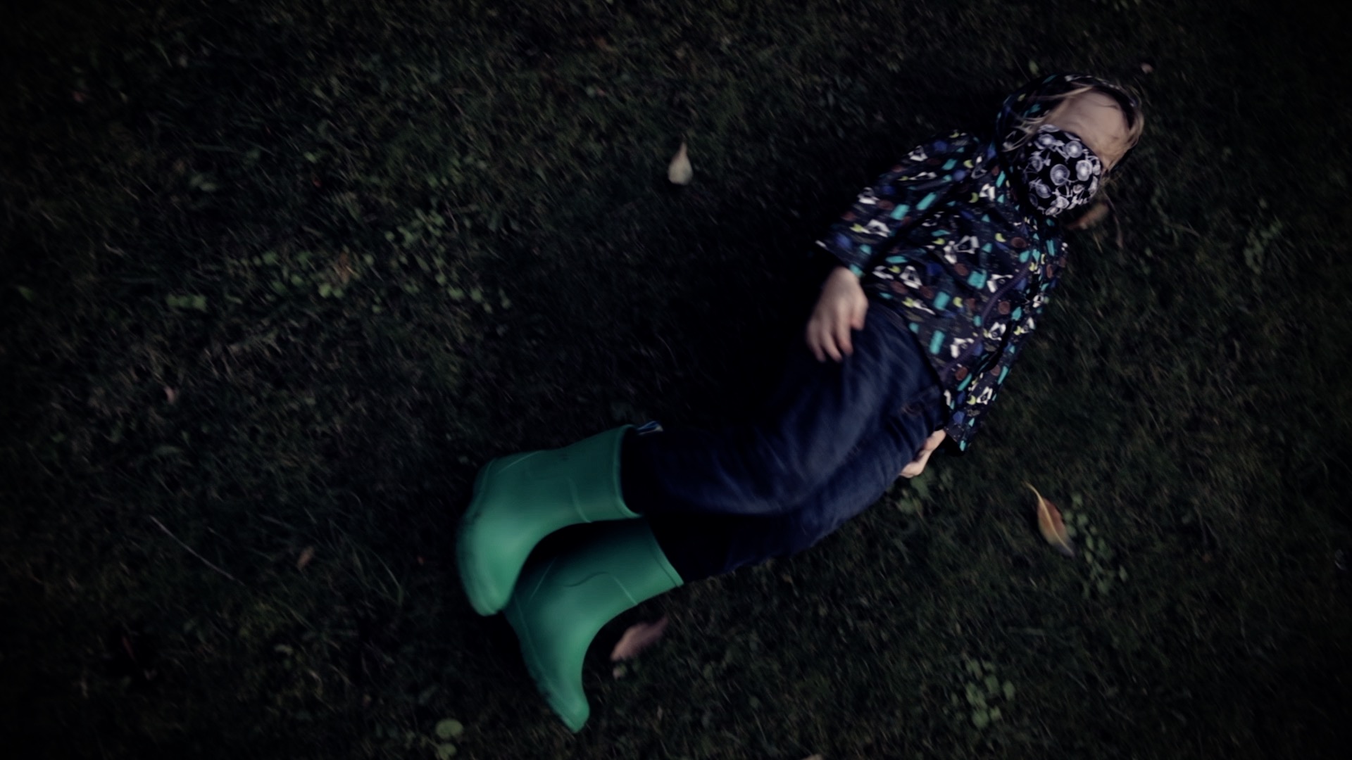 a boy rolling in the grass